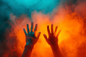 Vibrant Hands Reaching through Orange and Blue Powder Smoke in Surreal Abstract Background Concept