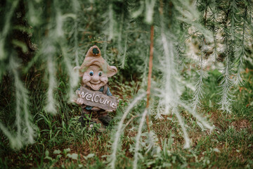 Valmiera, Latvia - August 5, 2023 - A garden gnome holding a 