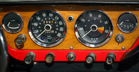 Front view and close up of a vintage car dashboard.	
