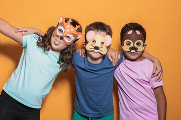 Playful children wearing animal masks in studio