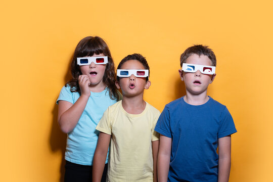 Three Children Sporting 3D Glasses on Yellow Background
