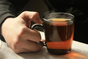 A man drinks hot tea