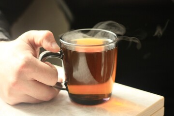 A man drinks hot tea