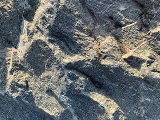 Close up shot of dramatic dark rocks, covred in bright lichen. background or texture. slabs background