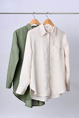 Linen shirts hanging on wooden hangers - 791602203