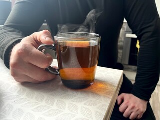 A man drinks hot tea