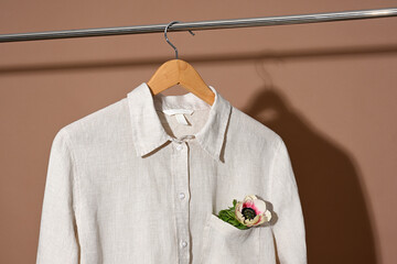 Linen shirt hanging on wooden hanger close up - 791602613