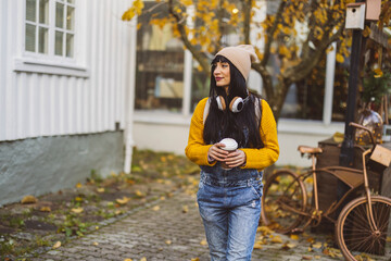 Autumn Vibes: Fashionable Woman with Coffee and Headphones