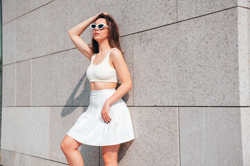 Young beautiful smiling hipster woman in trendy summer white tennis skirt and tank top clothes....