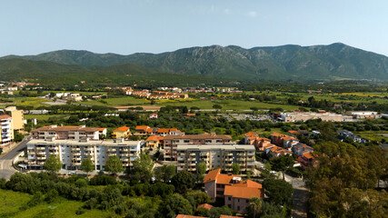 Fototapeta na wymiar Aerial view on buildings with mountains in the background in Iglesia, southern Sardinia, Italy.