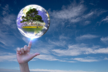 Earth day save the world by sustainability business concept kid hand pointing at globe with tree city and field inside, Elements of this image furnished by NASA