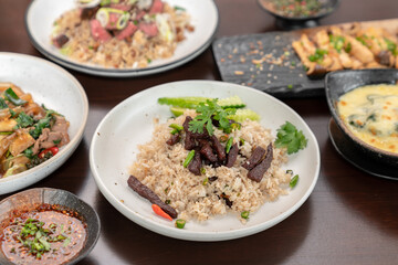 Asian dried beef fried rice with vegetables on table meal.