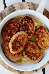 Chicken cutlets in a frying pan. top veiw