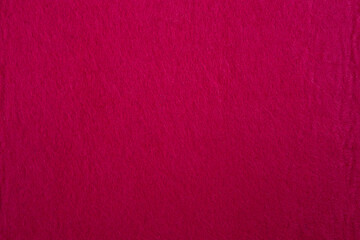 Felt fabric texture with visible fiber, red color abstract pattern backdrop