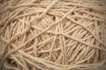Ball or bundle of jute thread close up soft focus texture, abstract backdrop