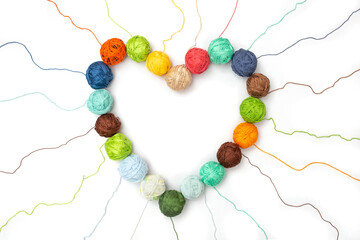 Threads and clews or Skeins arranged in the shape of a heart isolated on a white background