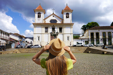Tourism in Mariana, Brazil. Back view of young tourist woman in Mariana Cathedral square in Minas Gerais, Brazil.