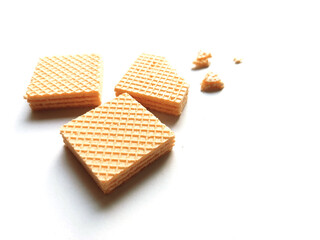 Orange flavored wafer snacks on a white background.