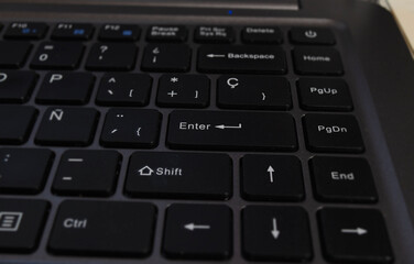 closeup of enter key, selective focus of enter key on notebook keyboard
