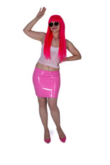 full body woman in sunglasses, dressed like doll. Beautiful sexy woman, long legs, in camisole and pink skirt on white background. Red hair girl wears pink wig with fringe. Posing, modeling