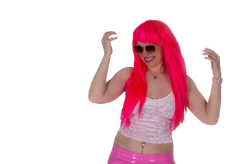 woman in sunglasses, dressed like doll. Beautiful sexy woman, in camisole and pink skirt on white background. Red hair girl wears pink wig with fringe. Posing, modeling, showing emotions, surprise