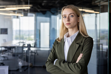 Confident businesswoman standing in modern office space