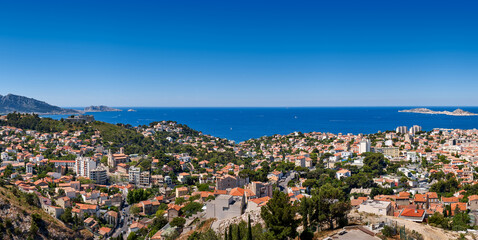 Summer view of Marseille overlooking rooftops with Mediterranean Sea (Bompard neighborhood). Bouches-du-Rhone, Provence-Alpes-Cote d'Azur, France - obrazy, fototapety, plakaty