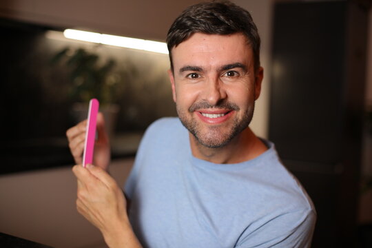 Judgmental looking man doing his nails