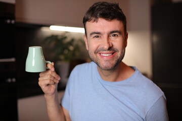  Sleepy looking man holding coffee cup upside down 