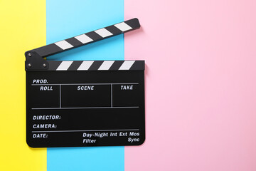 Obraz premium Clapperboard on color background, top view. Space for text
