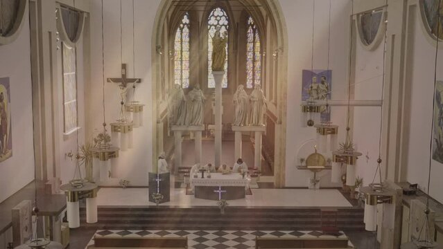 Christian priests standing at sanctuary and crossing themselves during Holy Mass ceremony in cathedral wide shot. Procession of Ministers, religious liturgy concept