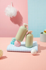 Organic shampoo or shower gel for baby filled unlabeled bottles with some bath accessories over colorful background in bathroom. Baby hygiene products designing, branding