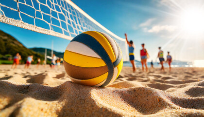 Extreme close-up and bottom view of a volleyball ball on sandy beach with blur image of players...
