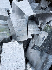 Blocks of aluminium covered with rain drops