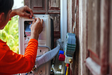 Air conditioning technicians install new compressor air Use a screwdriver to install the air...