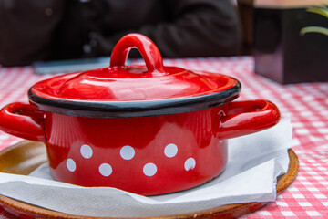 Traditional Slovak Ukrainian Russian cabbage soup with sausage and smoked meat served in retro red...