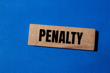 Penalty word written on wooden block with blue background. Conceptual penalty symbol. Copy space. - obrazy, fototapety, plakaty