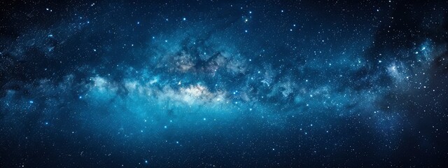 A panoramic view of the Milky Way galaxy, with stars twinkling in the dark blue sky.