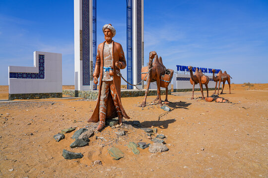 Sculpture of a camel train caravan along the ancient silk road at the gateway to the Khorezm Region of Uzbekistan, located along the A380 highway in the Kyzylkum Desert in Central Asia