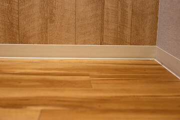 Wooden floor and wall with skirting boards