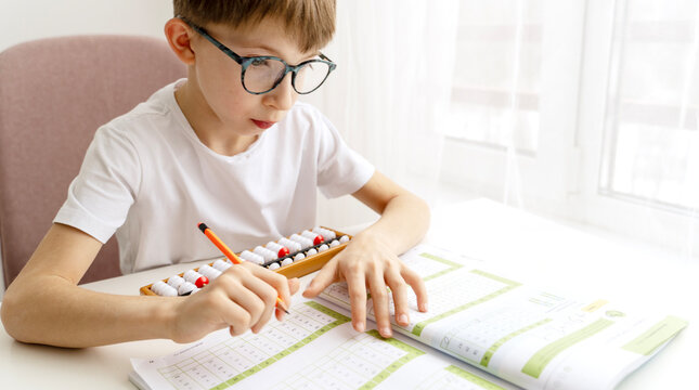 boy student doing mental arithmetic on the abacus - Powered by Adobe