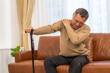 Sick unhappy senior adult elderly man touching her muscle injury Lower back suffering from muscles back pain at home.physical injury and healthcare problem