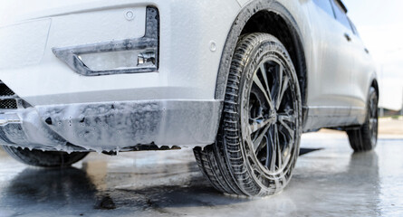 car at a self-service car wash covered in foam