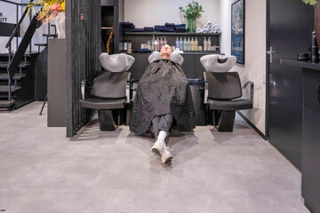 Person getting a hair wash at a salon