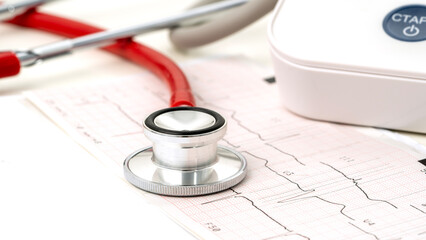 stethoscope on heart cardiogram on the table