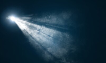 blue spotlight bright light beam on dark background