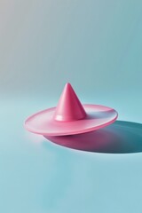 Fototapeta premium A pink object placed on a blue surface. Suitable for various concepts
