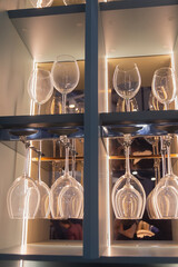 Shelf with many empty glasses in evening light