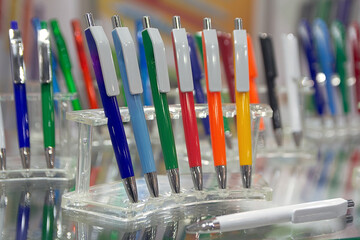 Modern colored plastic ballpoint pens on store display
