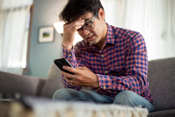 sad depression serious people from work,study stress problem.asian man feeling tired suffering using cell phone working work place.concept global economic,health problems